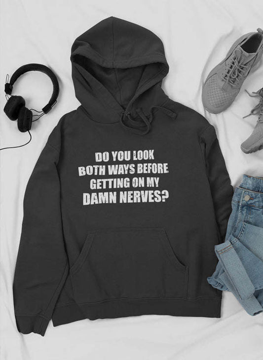 Black hoodie with front pocket, drawstring, and bold "Do you look both ways..." print