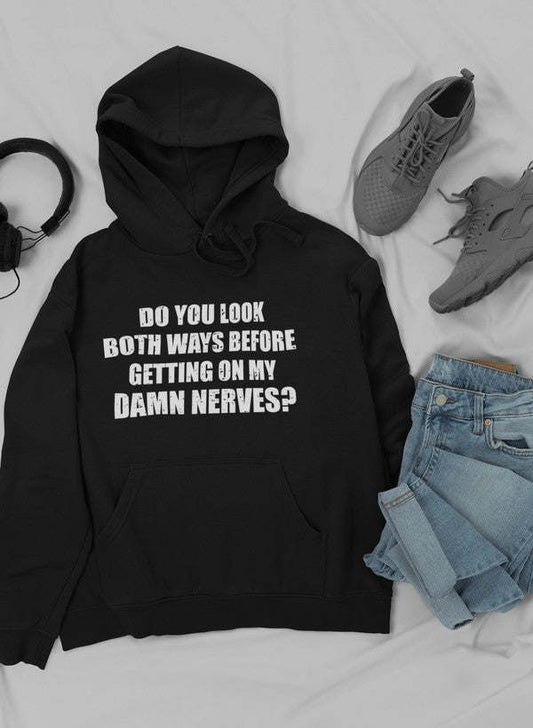 Black hoodie with front pocket, drawstring, and bold "Do you look both ways..." print