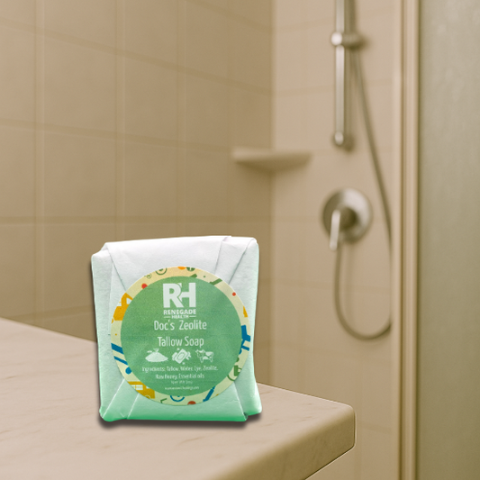 Wrapped tallow soap bar on a bathroom counter near the shower
