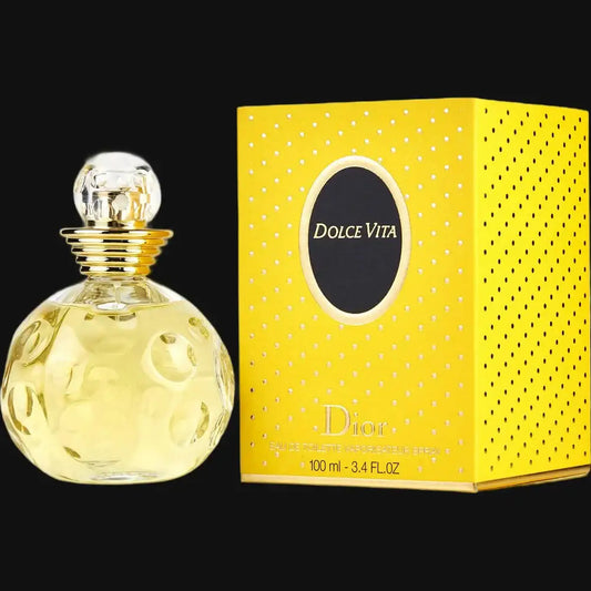 Eau de Parfum bottle with gold cap and yellow glass, next to gift box.