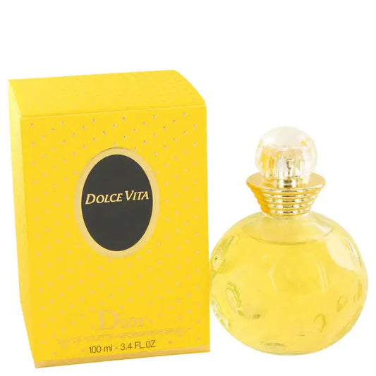 Yellow glass perfume bottle with gold cap beside Dior yellow gift box.
