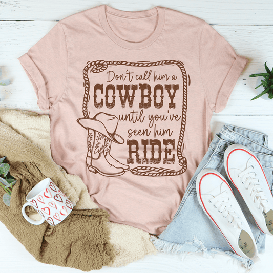 Peach cowboy graphic T-shirt with slogan, cowboy hat, and boots print