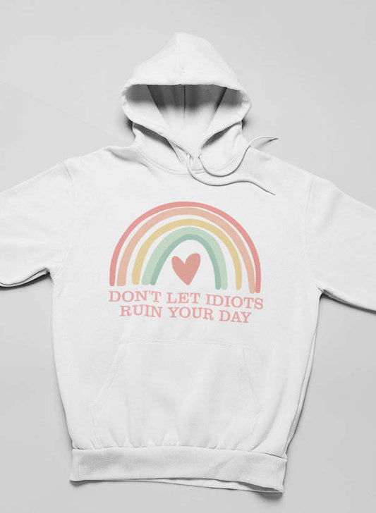 White pullover hoodie with rainbow heart graphic and quote text
