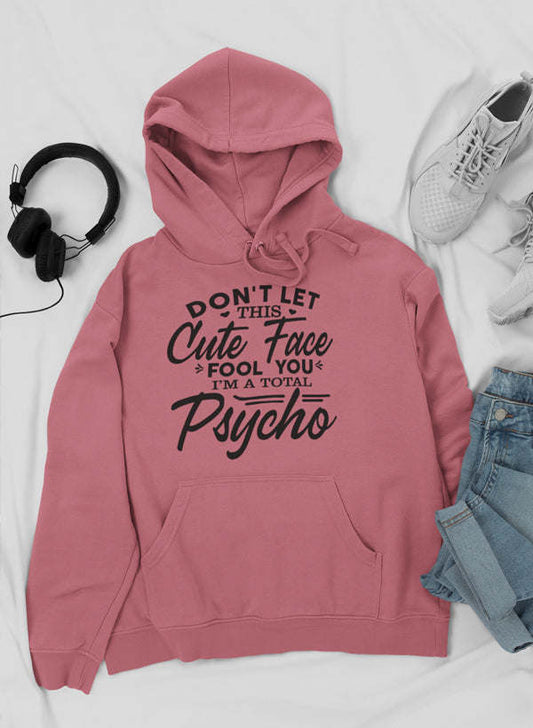Pink pullover hoodie with large front pocket and printed slogan graphic on chest