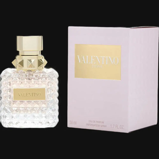 Valentino Donna perfume bottle with gold cap; clear faceted glass, on pink box
