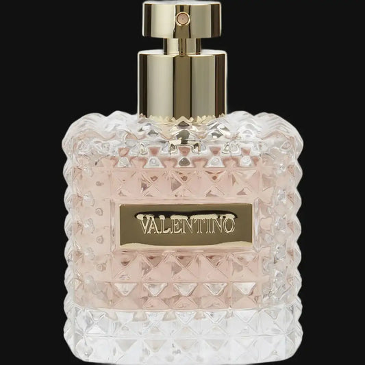 Valentino Donna perfume bottle, clear faceted glass with gold barrel cap and front label