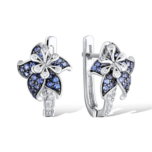 Blue and clear zircon flower earrings, silver-tone, front view on hinged hoops