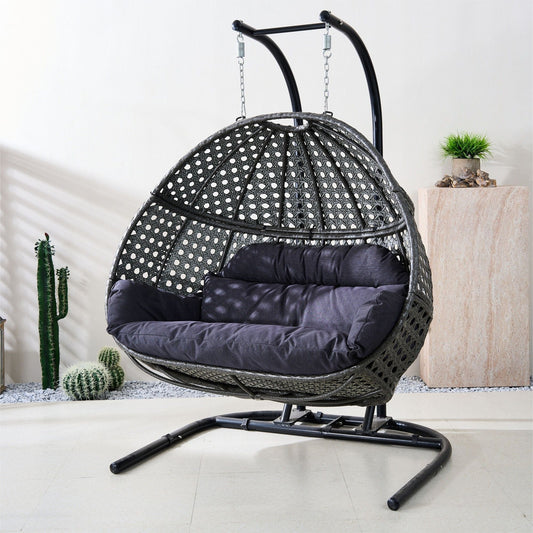Black woven egg swing chair with dark gray padded seat and hanging chains