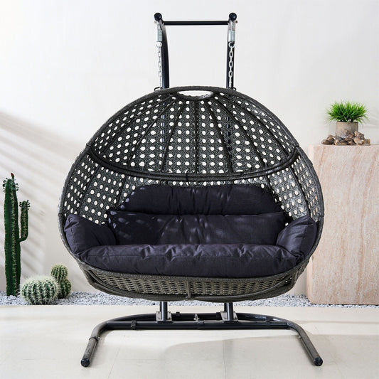 Black woven egg swing chair with dotted weave and dark gray cushion, front view