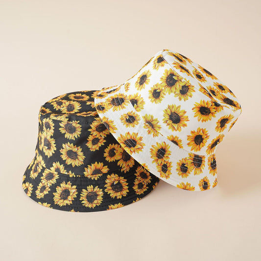 Reversible bucket hat showing white and black sunflower sides