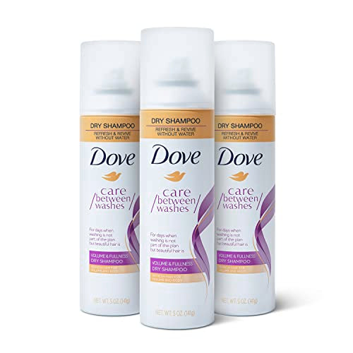 Dove dry shampoo spray canisters, front canister centered with orange and purple accents