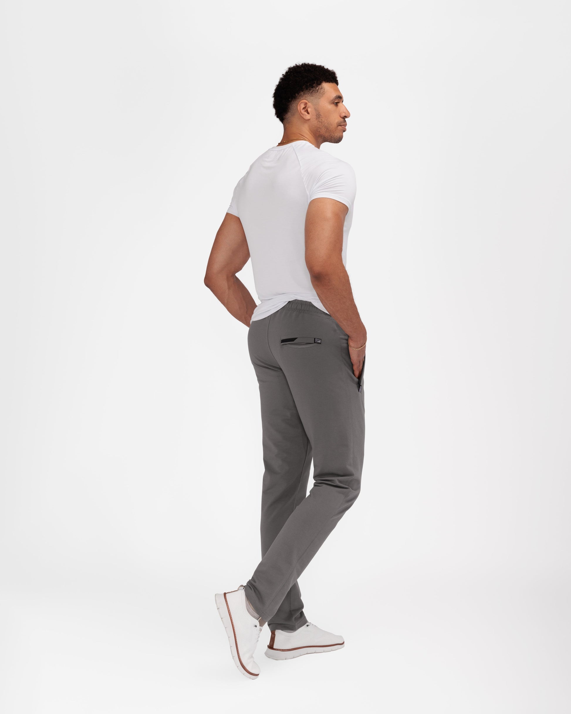 Dark gray tapered athletic sweatpants in side view with elastic waistband