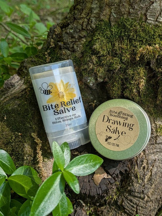 Bite relief drawing salve tin and clear stick container on a log