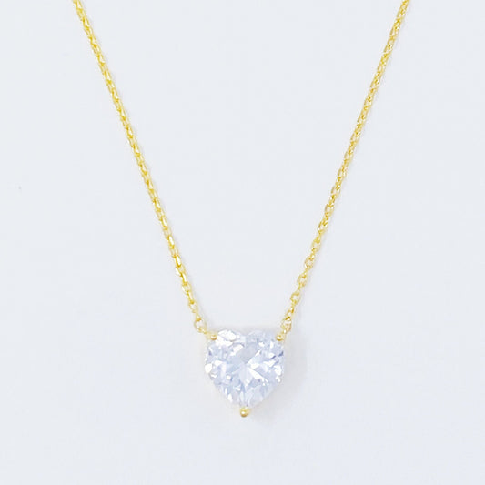 Gold solitaire pendant necklace with round clear gemstone centerpiece on a thin chain