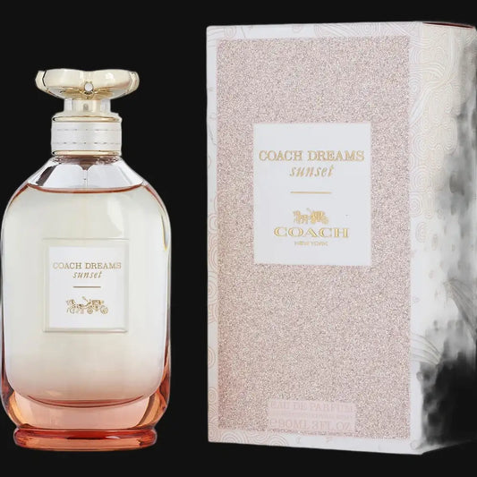 Coach Dreams Sunset perfume bottle with gold cap and pink tinted glass