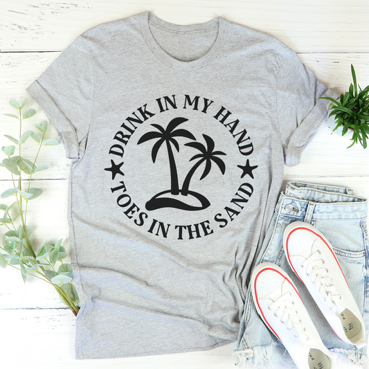 Heather gray crew-neck T-shirt with palm tree graphic and text 'FOOTES IN THE SAND'