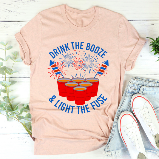 Heather peach crewneck T-shirt with fireworks and red drink cups graphic