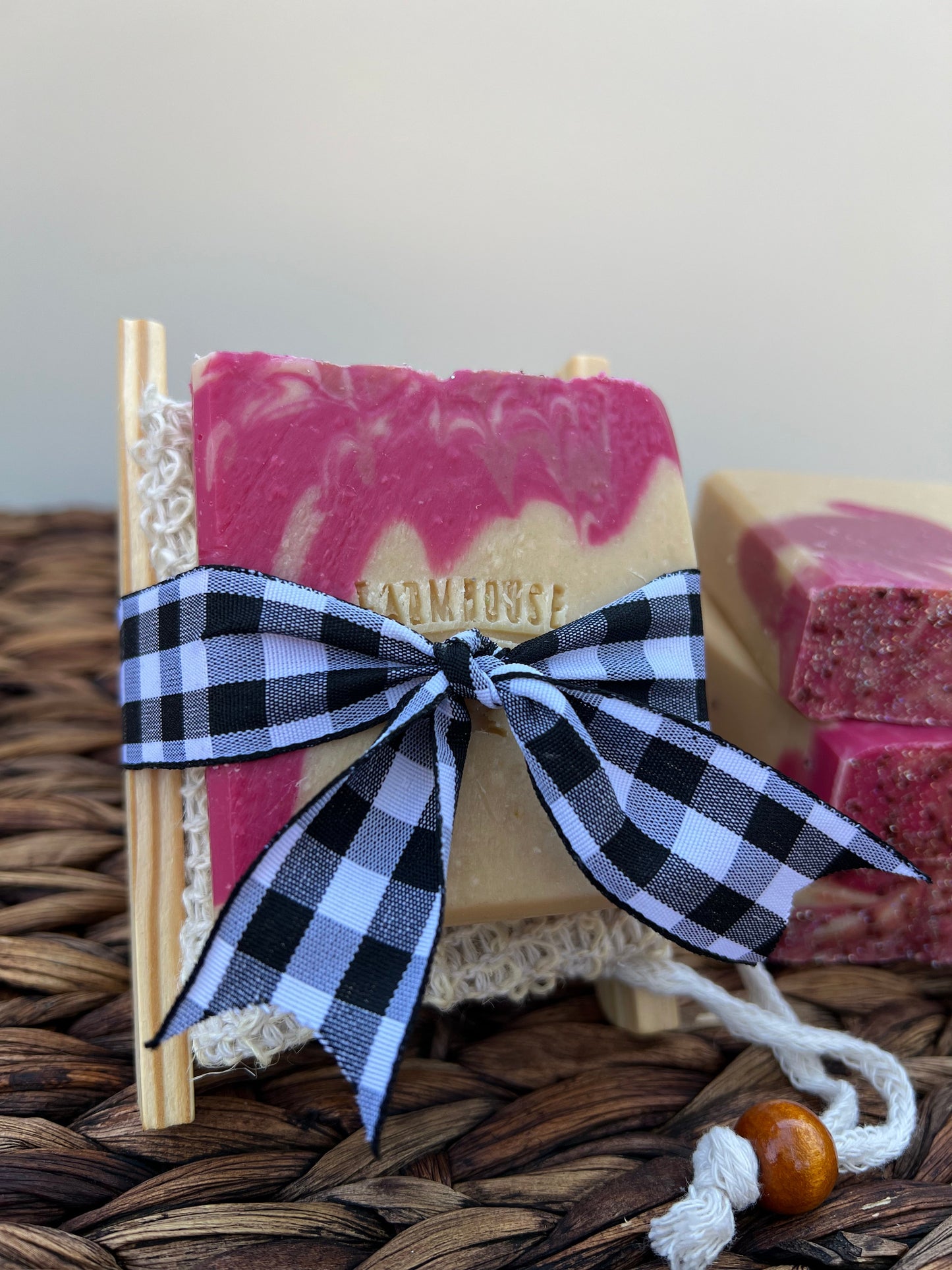 Pink soap bar tied with a blue plaid bow and white lace trim