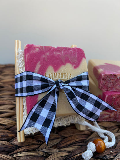 Pink soap bar tied with a blue plaid bow and white lace trim