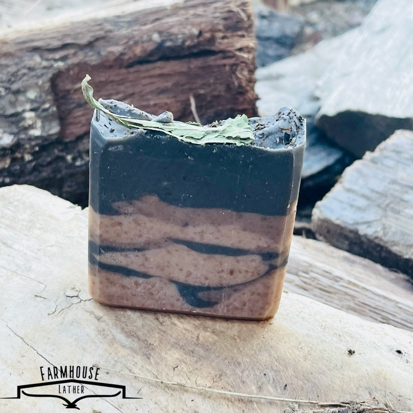 Striped bar soap with blue and cream layers, topped with green leaves