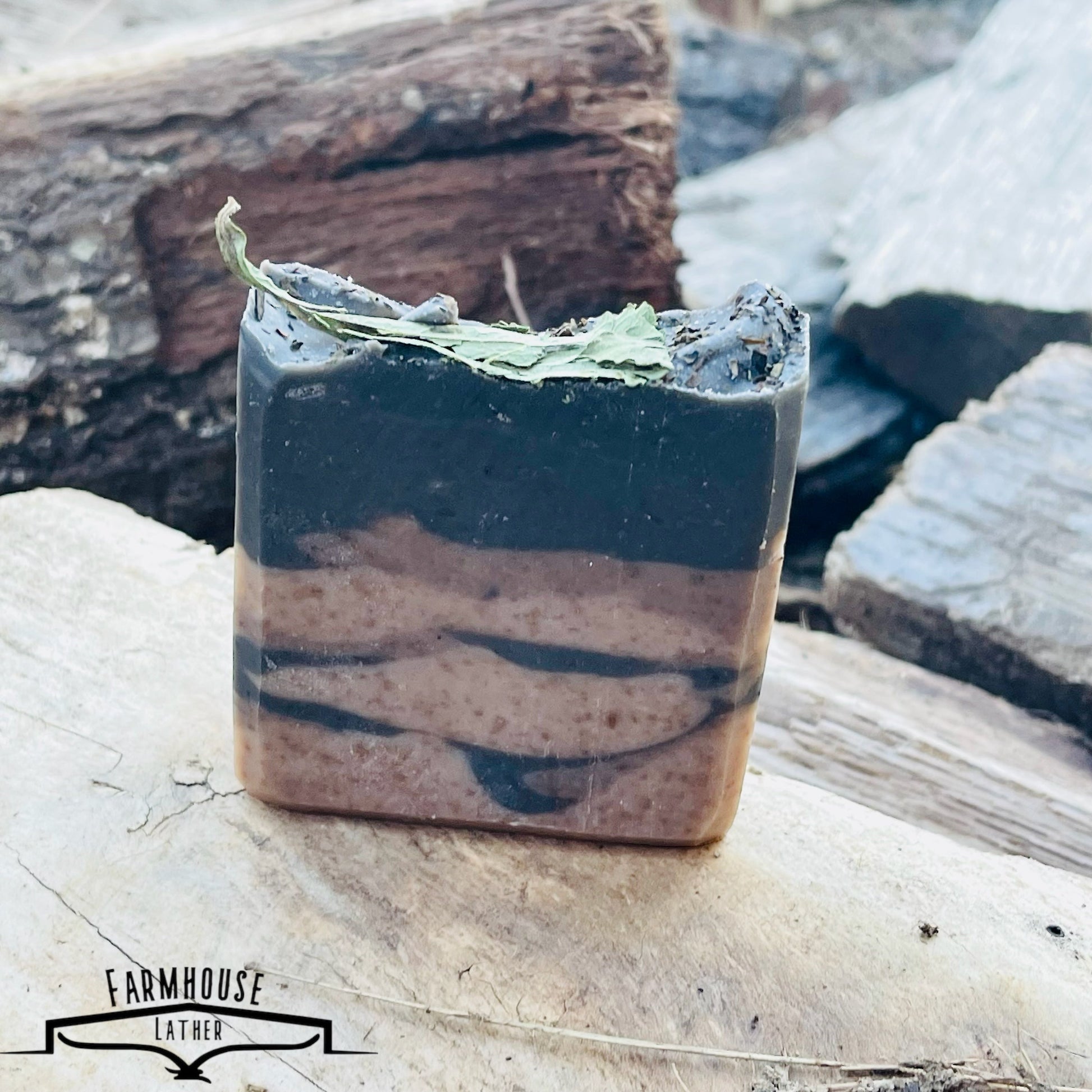 Striped bar soap with blue and cream layers, topped with green leaves