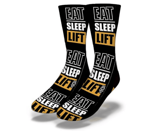 Black crew socks with repeated EAT SLEEP LIFT lettering and yellow panel stripes