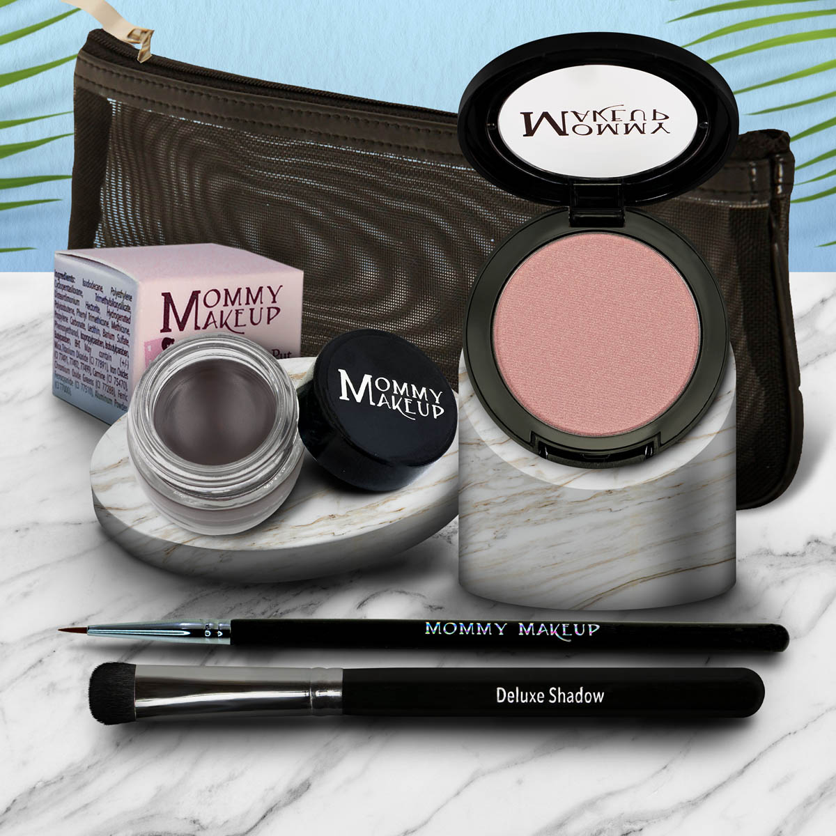 Eye makeup set with pink eyeshadow pan, dark brush, and purple gel pot