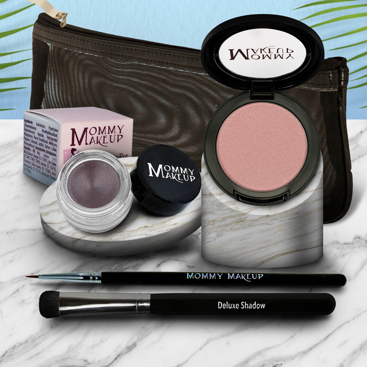Eye makeup set with pink eyeshadow pan, dark brush, and mauve gel pot