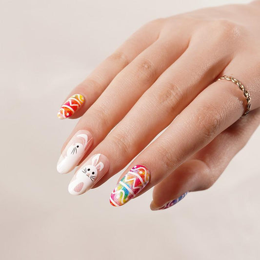 Easter eggs and bunny nail art on white nails with colorful egg and bunny faces