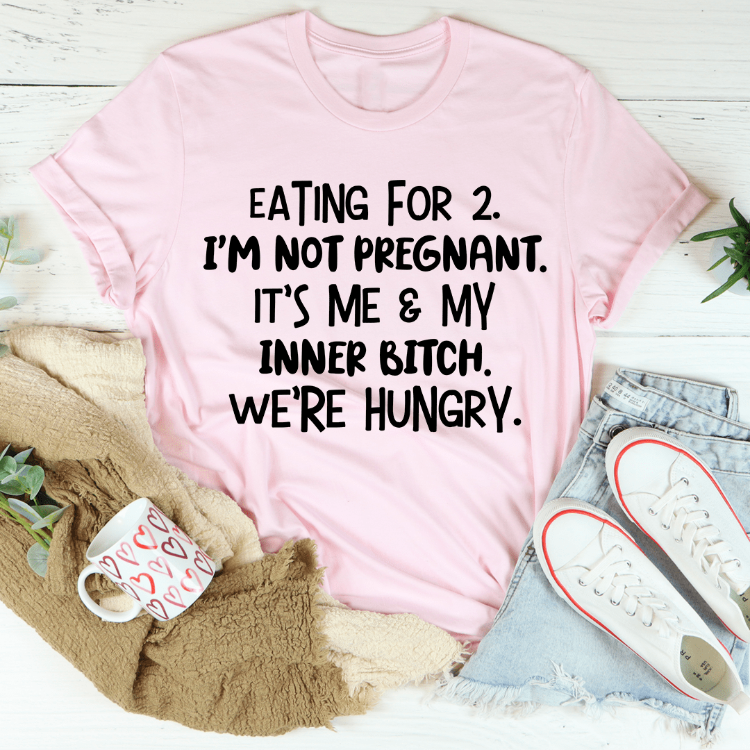 Light pink crewneck T-shirt with black slogan text: "EATING FOR 2... WE'RE HUNGRY."