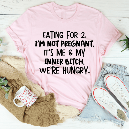 Light pink crewneck T-shirt with black slogan text: "EATING FOR 2... WE'RE HUNGRY."