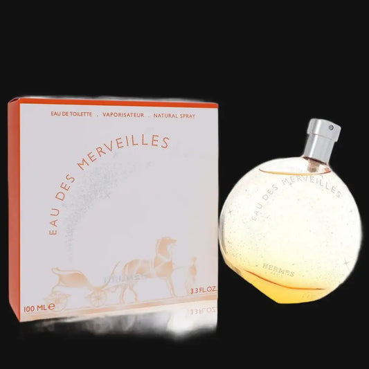 Women’s perfume bottle with spray and 100 mL box, round clear glass with orange tint