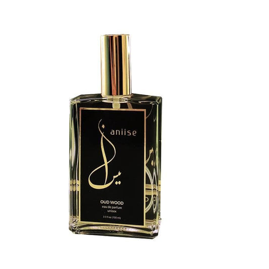 Eau de parfum spray bottle, gold cap, black anijise Oud Wood label.