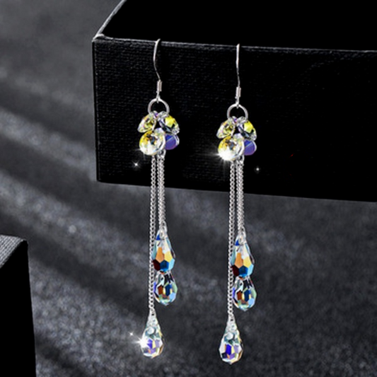 Silver teardrop dangle earrings with yellow, blue, and rainbow faceted crystals
