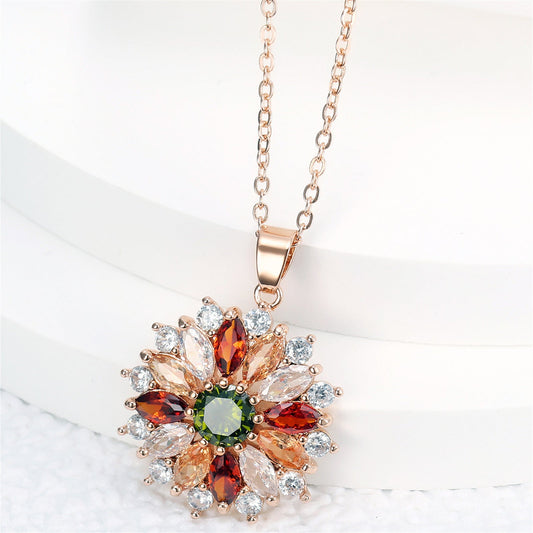Rose-gold flower pendant necklace with multicolor stones on a cable chain.