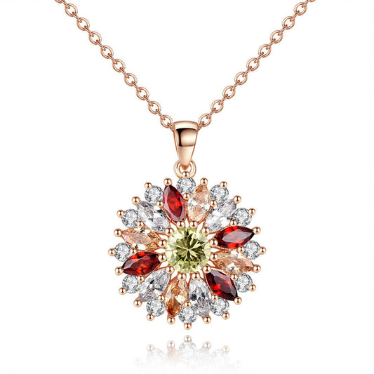 Rose-gold floral pendant necklace with red, green, and clear stones on chain.
