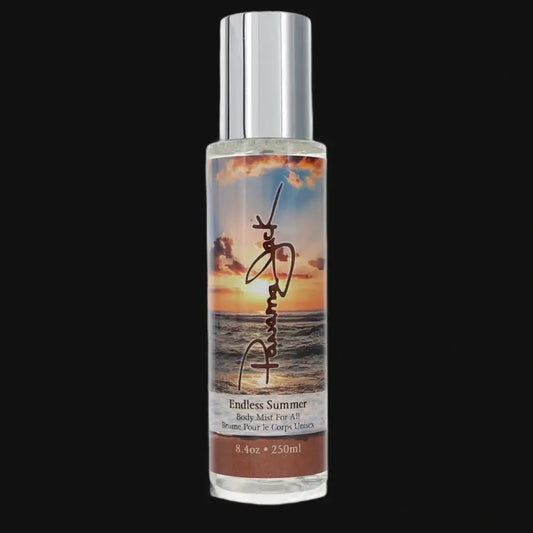 Perfume spray bottle with metallic cap, featuring sunset beach label artwork
