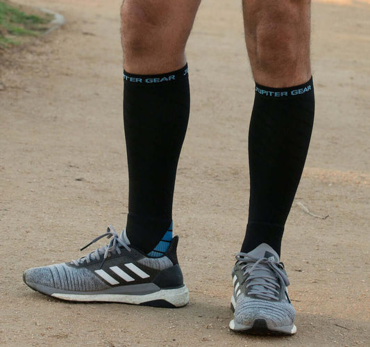Black compression socks with JUPITER GEAR branding on cuffs, worn with running shoes