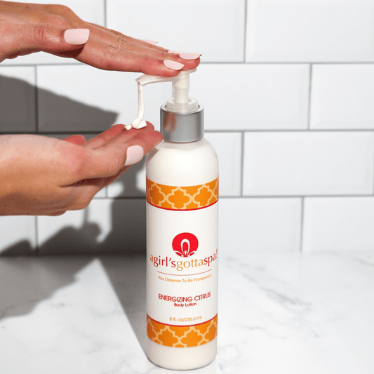 Body lotion bottle with white pump and orange patterned label, citrus body lotion