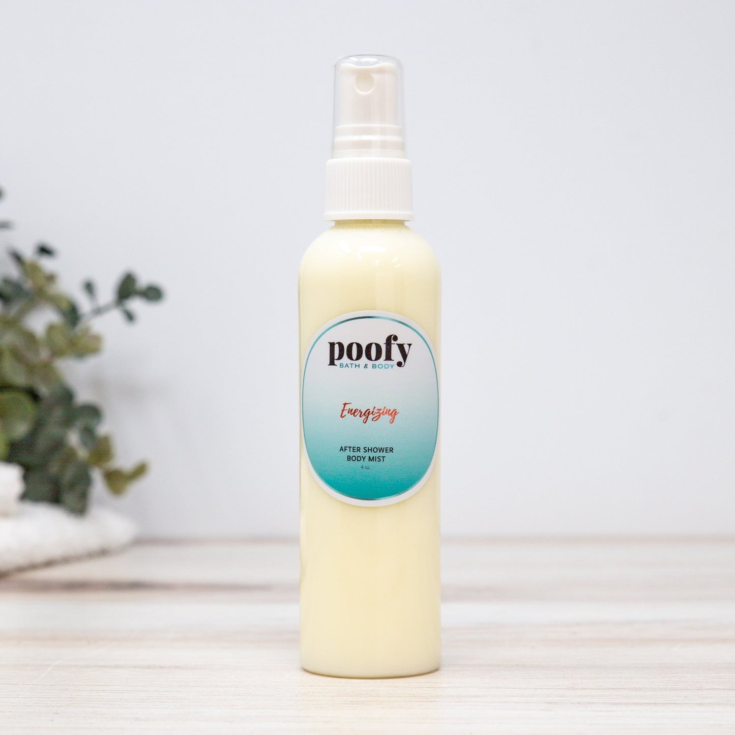 Energizing after-shower body mist bottle with spray pump and poofy label