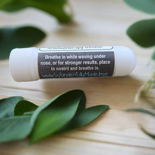 White inhaler stick showing usage instructions on tube