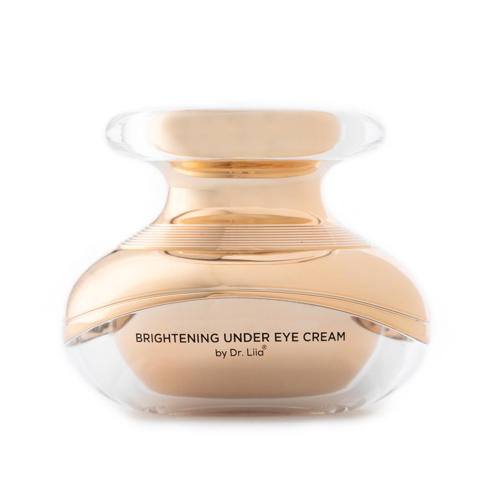 Brightening under eye cream jar with clear lid, light beige cream inside.