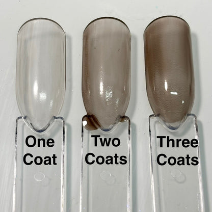 Nail polish coat samples showing light to deeper brown from one to three coats.
