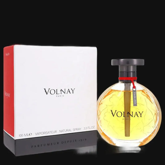 Women’s perfume bottle with dark cap and red collar, next to Volnay box