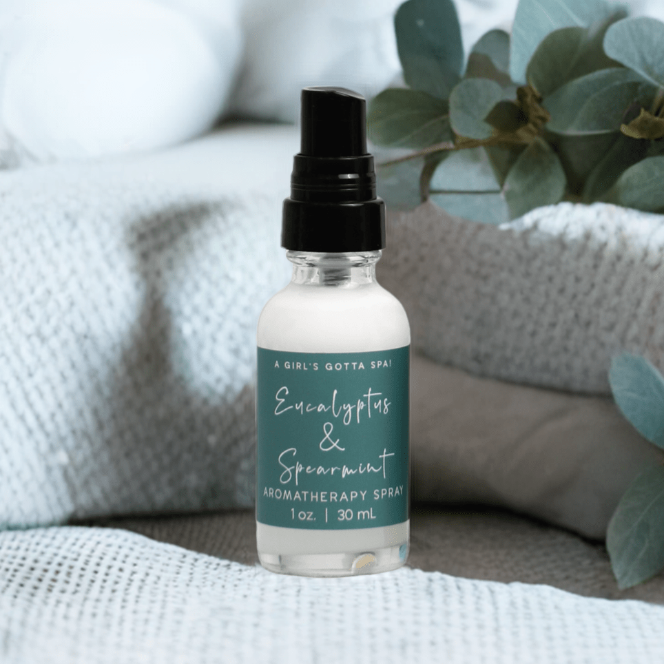Eucalyptus and spearmint aromatherapy spray bottle on couch with black mist top
