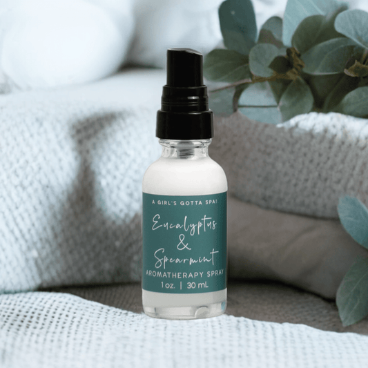 Eucalyptus and spearmint aromatherapy spray bottle on couch with black mist top