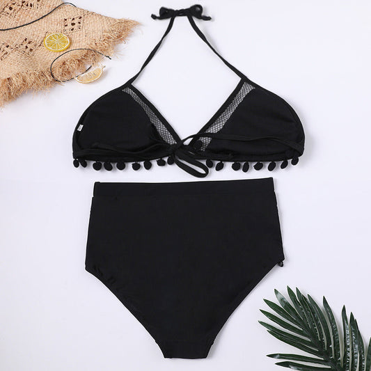 Black halter bikini top with mesh inset and pom-pom trim, paired with matching bottoms