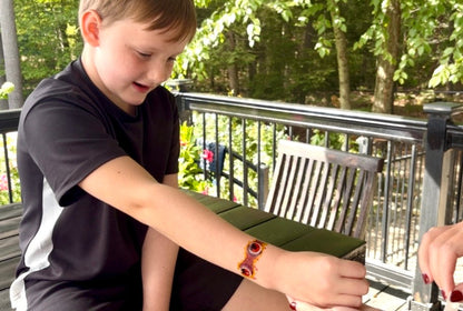 Kids temporary tattoo band on arm with red eyeball motifs