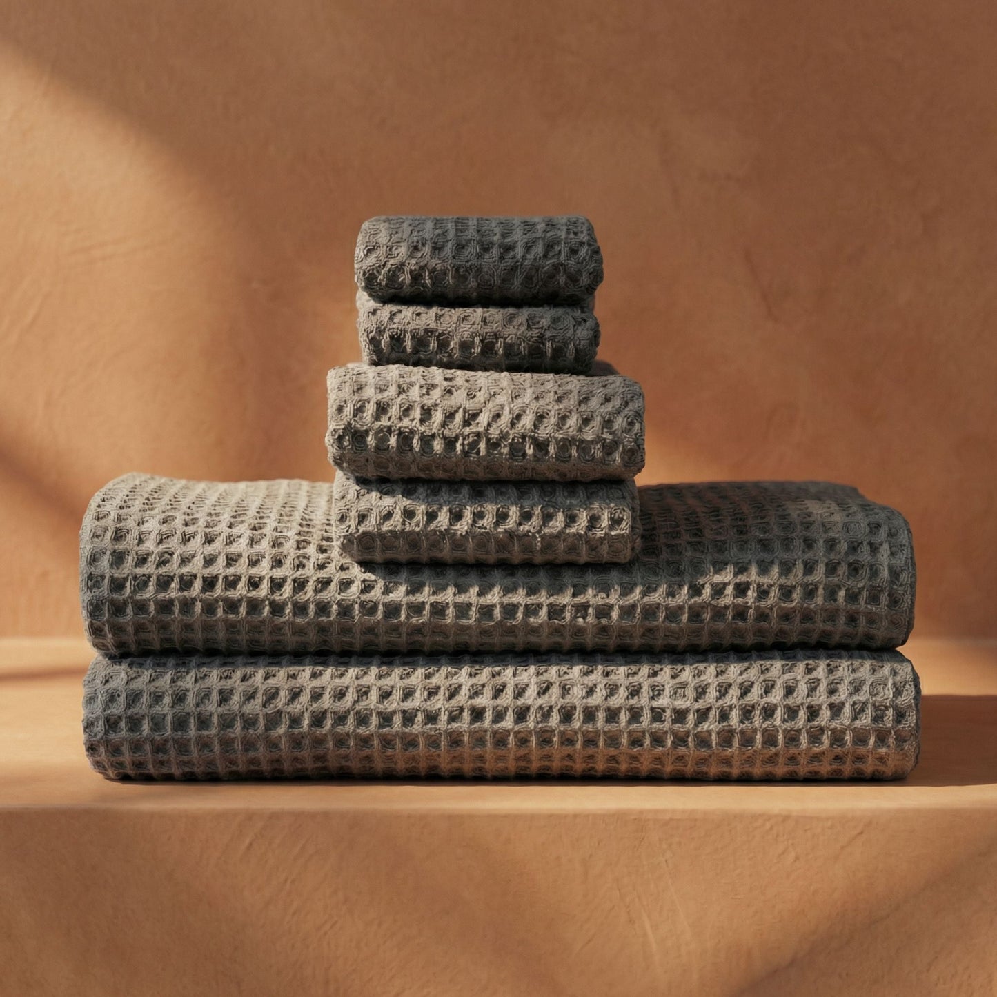 Charcoal waffle cotton towels stacked with waffle weave and folded hems