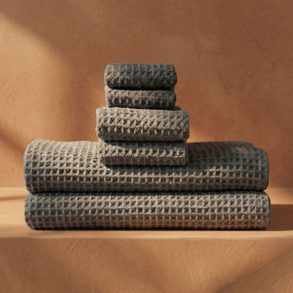 Charcoal waffle cotton towels stacked with waffle weave and folded hems